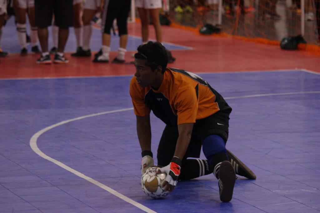 Di Bufala player Alex warming up before a futsal match